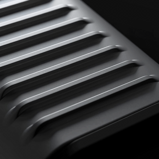 Macro detail of the Super Tiny showing the vertical ribbed thermal pattern and USB-C port collar
