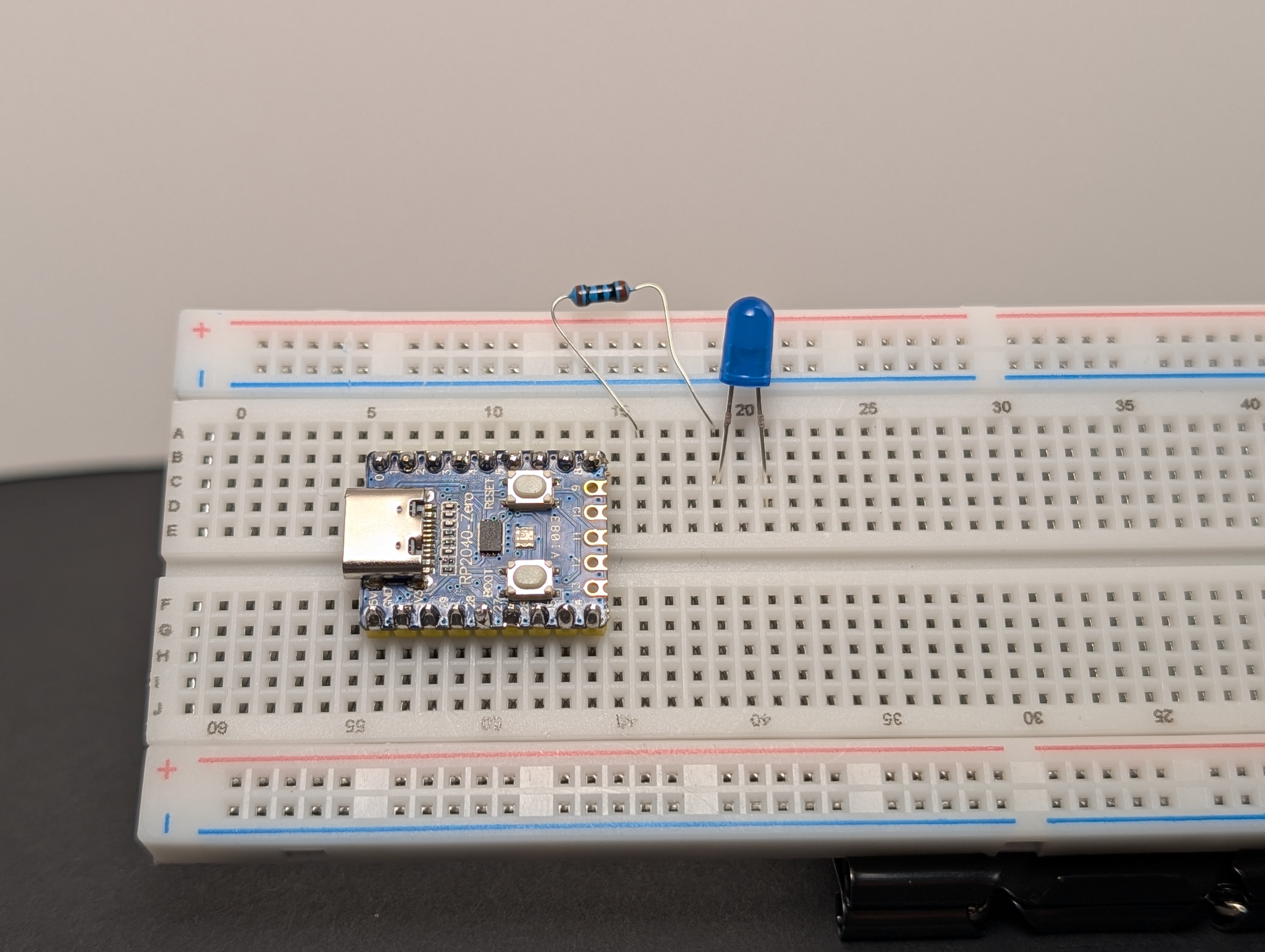 Put a resistor in series with the LED, connected to the long leg (+).
