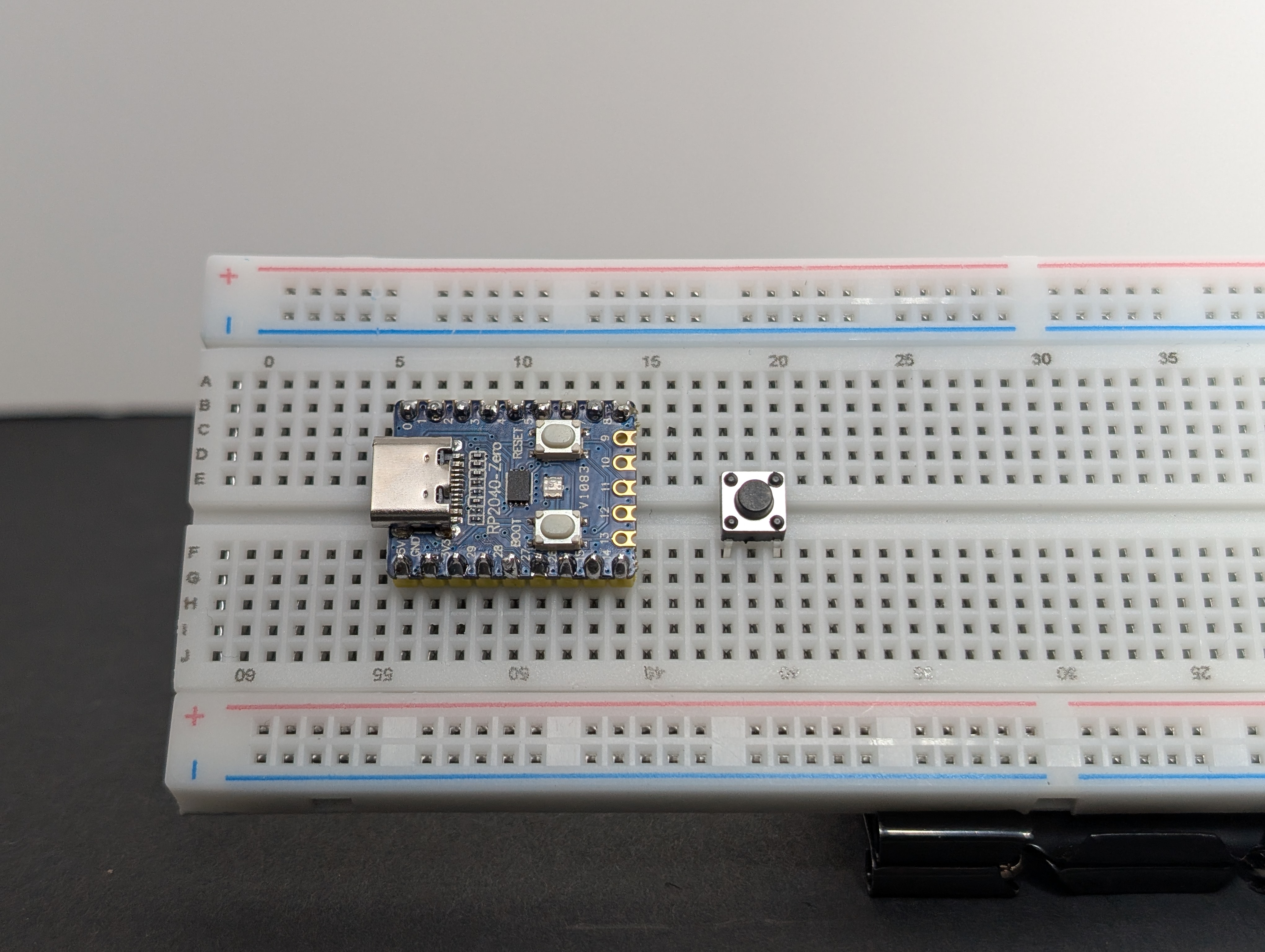 Place the pushbutton so it bridges the center gap of the breadboard.