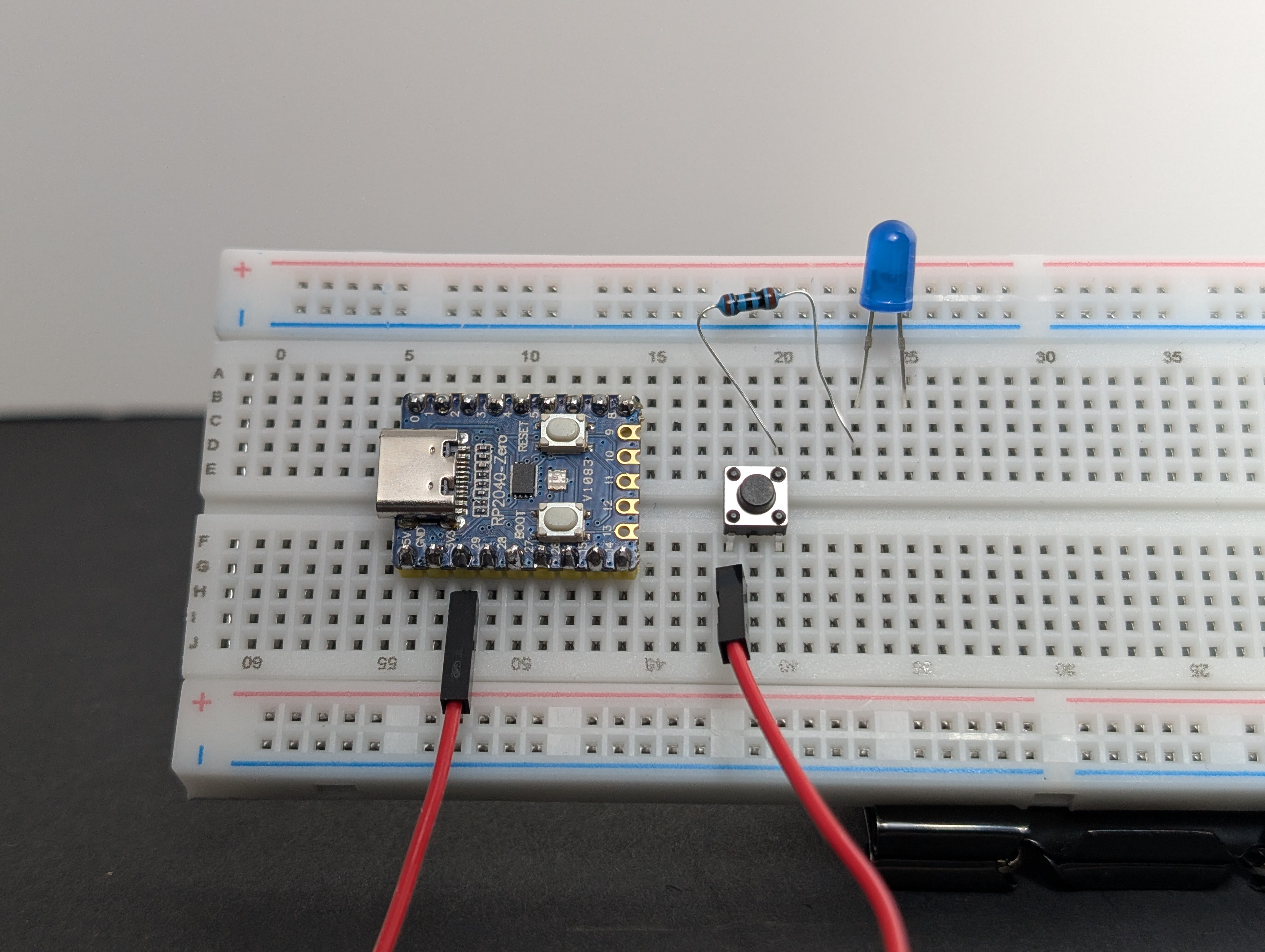 Using a jumper wire, connect 3V3 to the same row as the button leg that shares a row with the resistor.