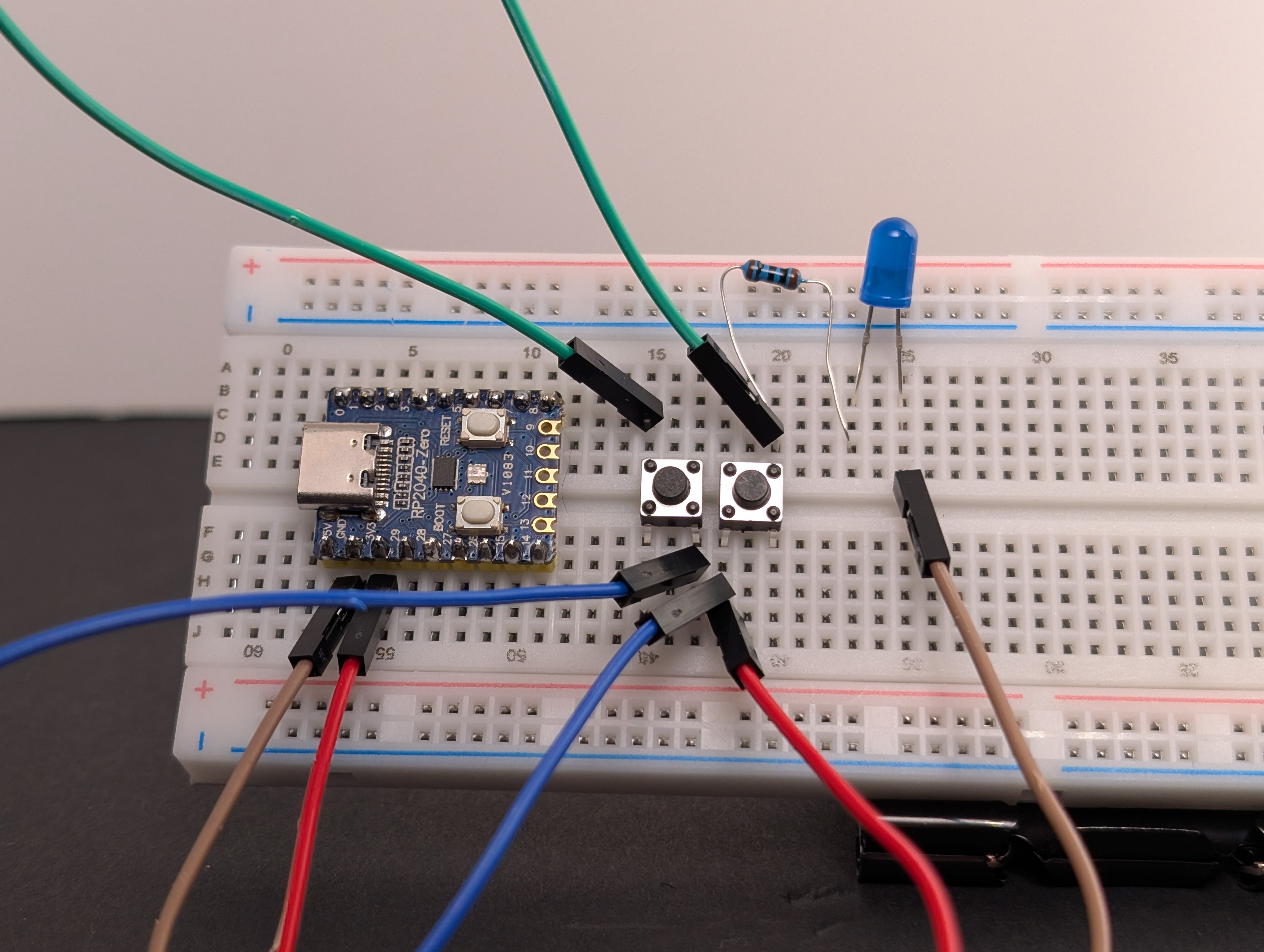 Using a jumper wire, connect the other side of both buttons to the same row that leads into the resistor and LED.
