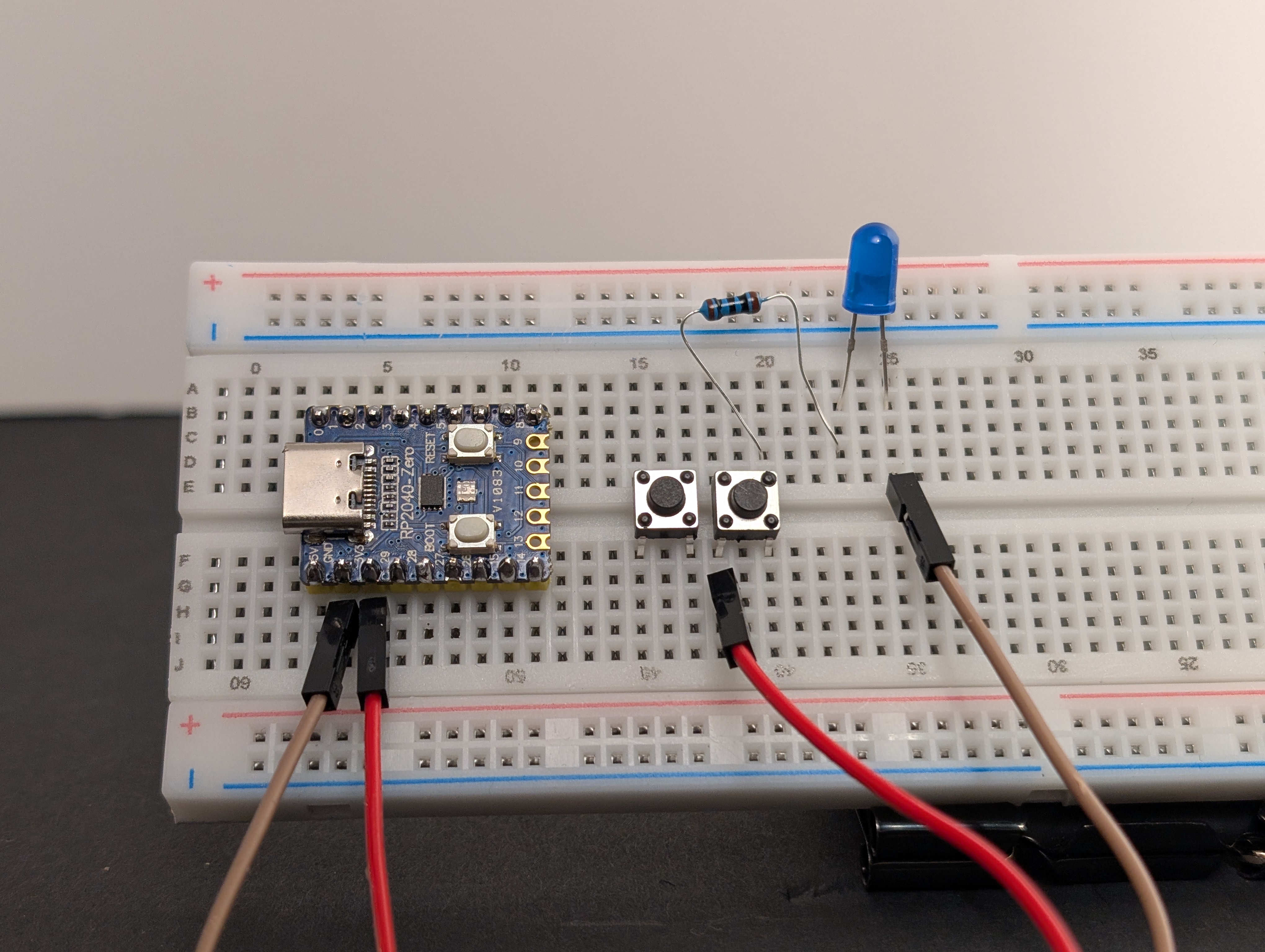 Add a second button, making sure it bridges the center of the breadboard.