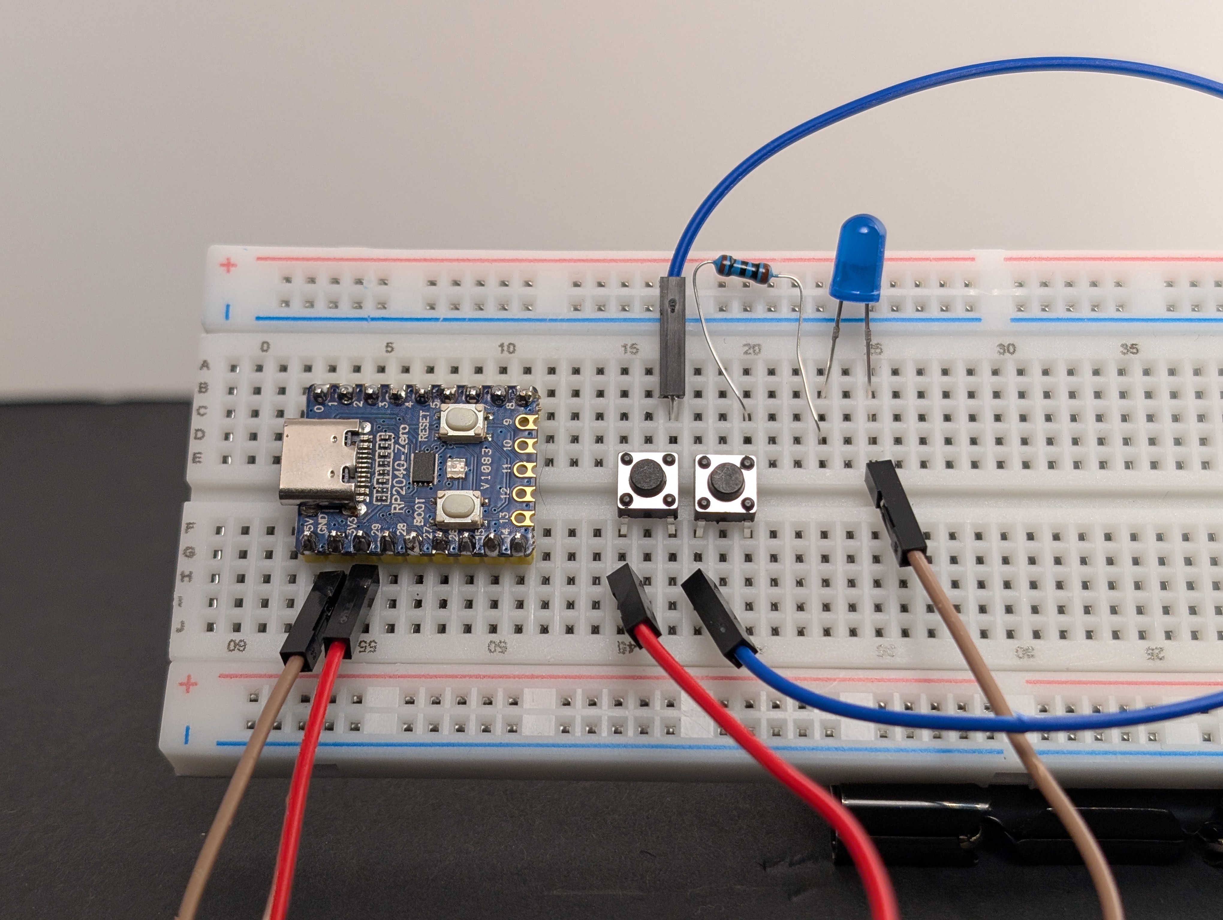 Using a jumper wire, connect the first button to the second button.