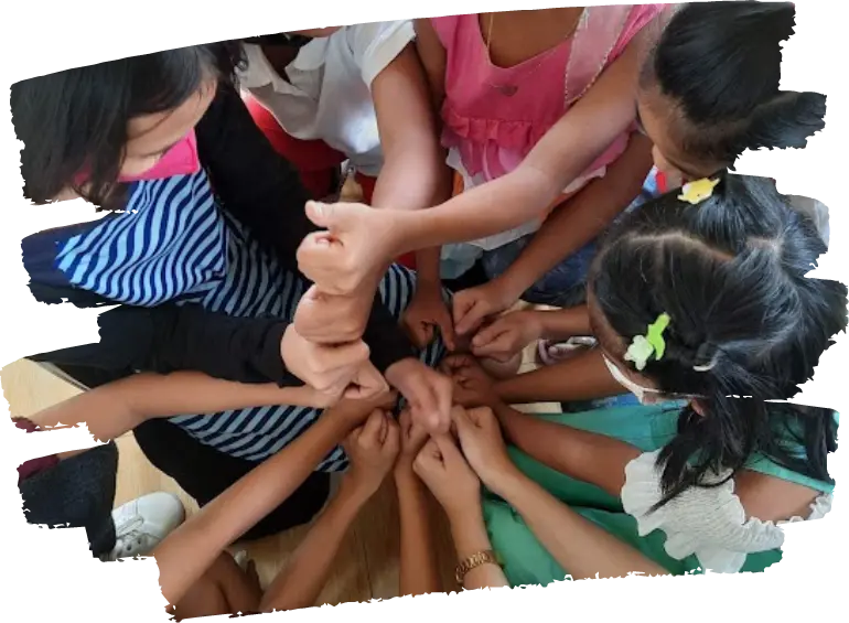 A Photo of Kids Holding their hands together in a circle