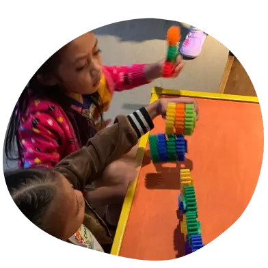 Two Kids Playing with Toys on the Table