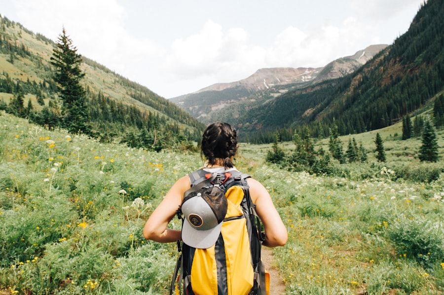 Backpacker walking along a mountain trail at sunrise with a lightweight pack