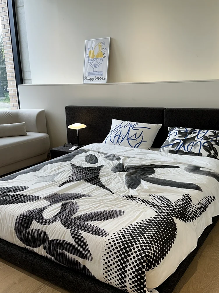 alt:ハイコントラストなパターンの寝具とデザイナーズランプが配されたショールームのベッドルーム - ソウル近郊の美学、ムーブメントラボ義王で体験する究極のインテリア・キュレーション