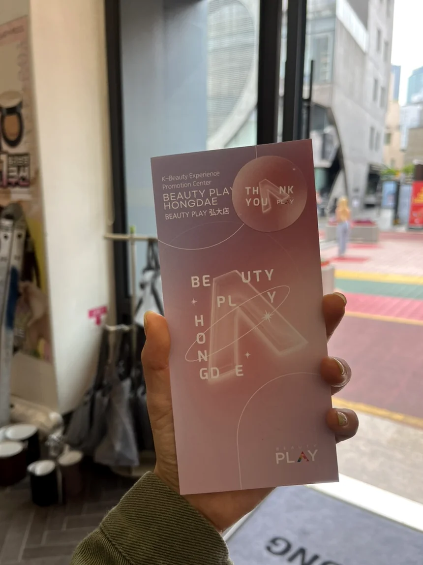 A visitor holding a sleek, pink-toned promotional guide that outlines the floor-by-floor K-beauty journey. - Unlocking the K-Beauty Ethos: A Discerning Guide to Beauty Play Hongdae