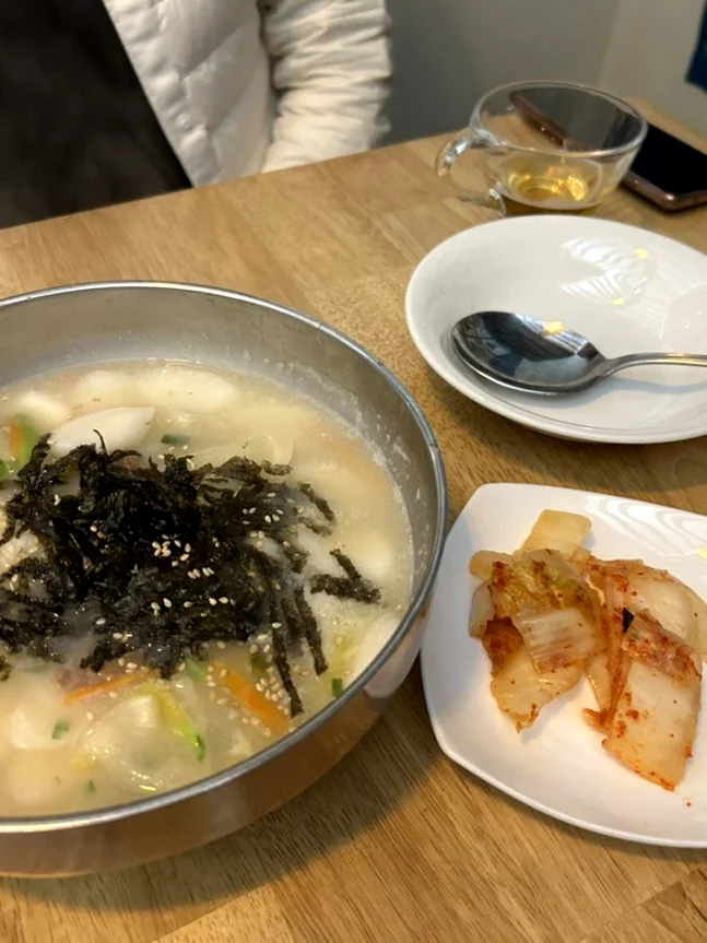 Authentic vegan Korean Rice Cake Soup served with fresh kimchi and seaweed garnish - A Sanctuary of Plant-Based Heritage: Exploring the 100-Year-Old Hanok of Vegan Insa