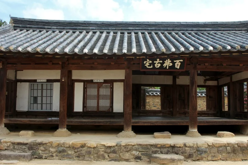 An expansive wide shot of a historic Hanok building, showcasing the intricate wooden architecture and the grandeur of the tiled roof. - A Sanctuary of Scholarly Grace: Exploring the Timeless Otgol Village in Daegu