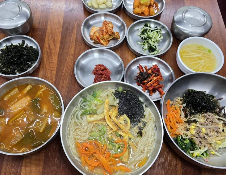 A top-down view of a traditional Korean meal served in brass and stainless steel bowls, emphasizing the cultural authenticity of the local cuisine. - A Sanctuary of Scholarly Grace: Exploring the Timeless Otgol Village in Daegu