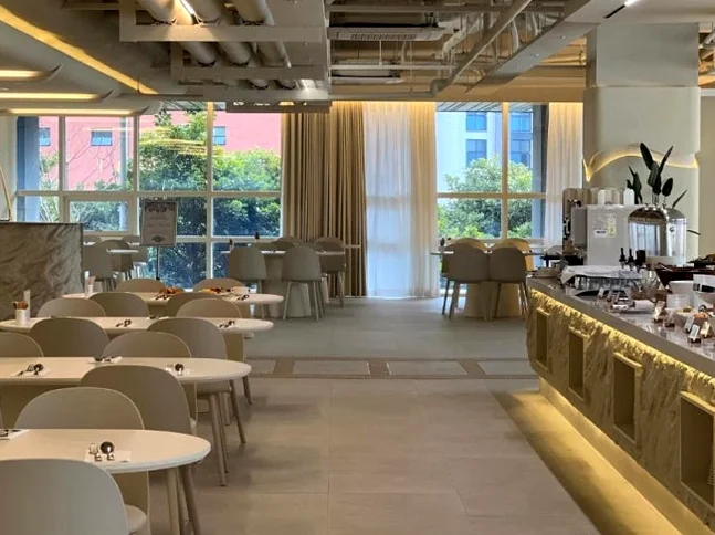 The brightly lit and stylish interior of the hotel restaurant designed for a comfortable dining experience - A Curated Stay in Seogwipo: The Unrivaled Value of The First 70 Hotel