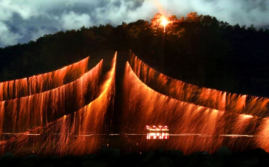 The ethereal glow of the Nakdong River reflecting the fire and lanterns during the festival - A Symphony of Falling Stars: The 450-Year-Old Fire Ritual of Andong Hahoe Village