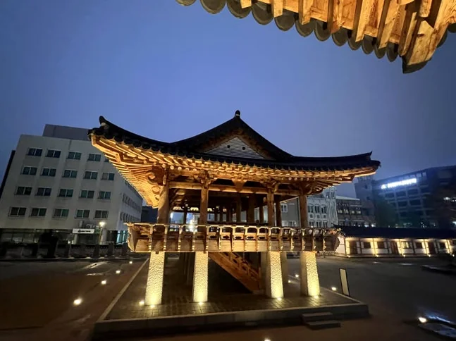 A poetic night perspective of a classic pavilion, elegantly framed by the dark, sweeping silhouette of Hanok eaves - Beyond the Palace Walls: Reclaiming the Administrative Soul of Jeolla Gam-yeong