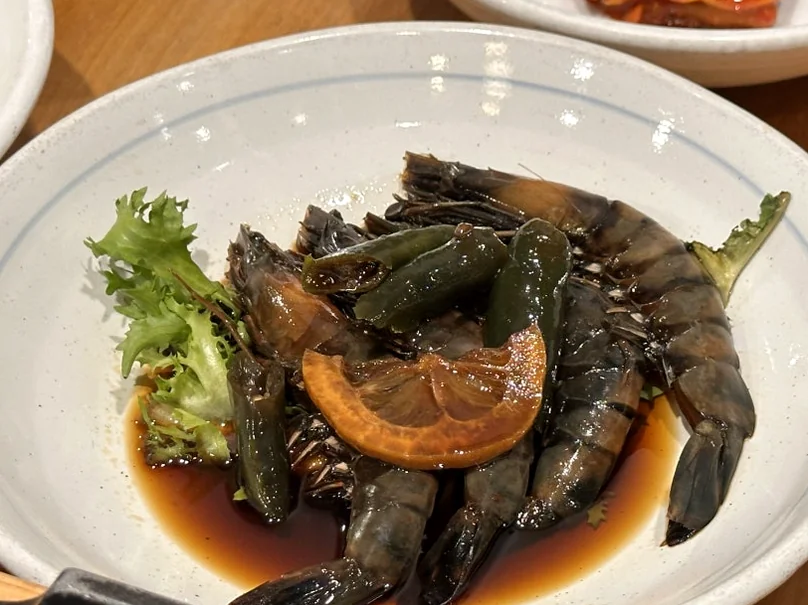 A plate of soy-marinated raw shrimp (Ganjang-saeu) decorated with lemon and sprouts, showcasing the freshness of the meal. - The Vertical Elegance of 죽녹원: A 2026 Masterclass in Bamboo Minimalist Living