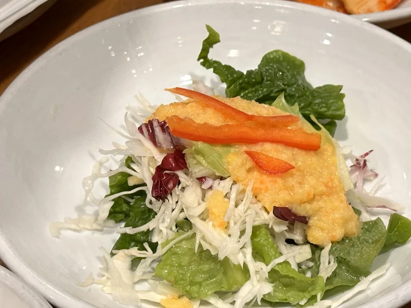 A fresh garden salad topped with a fruit-based dressing, presented in a clean white ceramic bowl. - The Vertical Elegance of 죽녹원: A 2026 Masterclass in Bamboo Minimalist Living