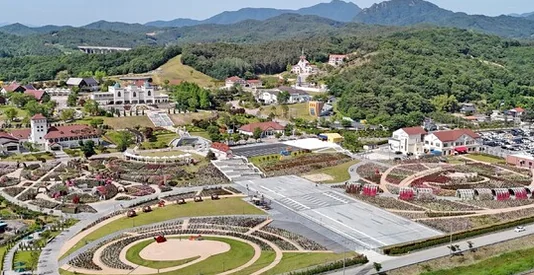 A stage set up for a performance within the rose-filled landscape - K-Life Hack: Imshil Cheese Theme Park's Inaugural Rose Festival in 2026