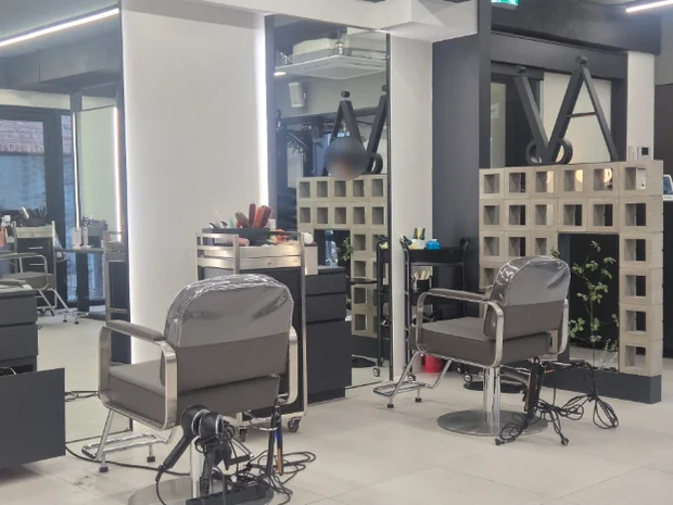 Detail shot of the styling area featuring industrial-chic aesthetic with sleek mirrors and comfortable seating. - A.NOI Hair Mapo Yeonnam (에이노이헤어 마포연남점): A Masterclass in Monochromatic Hair Artistry and Scalp Recovery