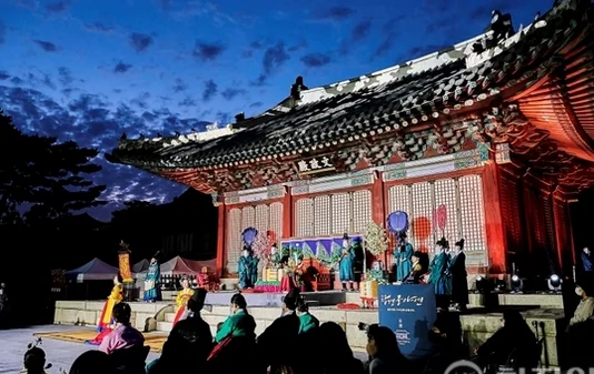 A participant being carefully dressed in traditional silk robes by heritage specialists - Royal Filial Piety Reimagined: The 2026 Changgyeonggung Yayeon Night Banquet