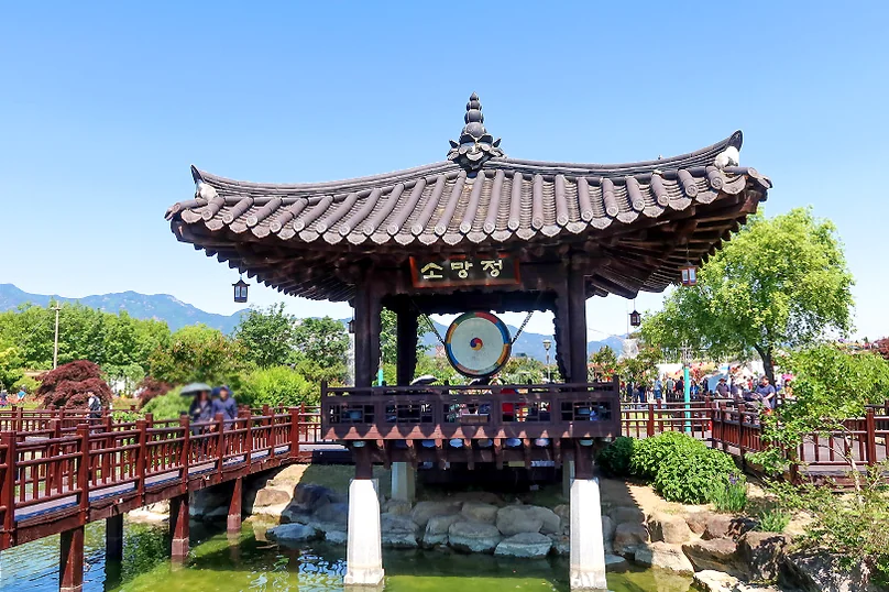 Sogang-jeong, a traditional Korean pavilion, sits elegantly over the water, offering a serene architectural contrast to the vibrant gardens. - The Floral Monarchy: Rediscovering Nostalgia at Gokseong Seomjingang Train Village