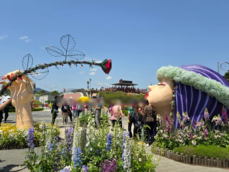 Tourists gathering around the signature floral sculptures, illustrating the popularity of the site's photo zones. - The Floral Monarchy: Rediscovering Nostalgia at Gokseong Seomjingang Train Village