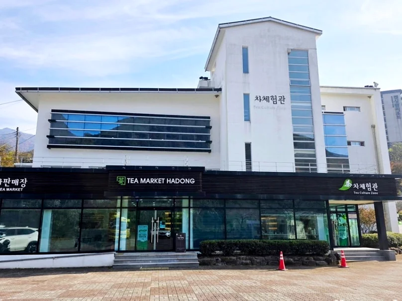 alt="青空の下、建物の規模とプレミアムな雰囲気を強調する河東野生茶博物館のモダンな白い建築外観" - 智異山の静寂を味わう：河東（ハドン）野生茶博物館で体験する韓国最高級のお茶文化ガイド