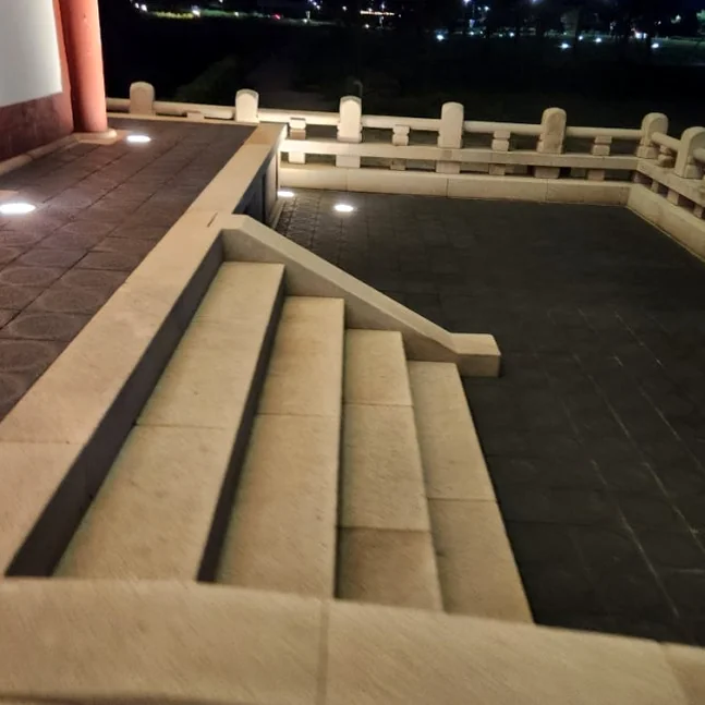 An artistic close-up of the stone steps and tranquil water feature adjacent to Woljeonggyo Bridge, where subtle lighting accentuates the texture of the ancient stones and the quiet reflection of the night. - Gyeongju Woljeonggyo: A Luminous Echo of Silla's Grandeur in 2026