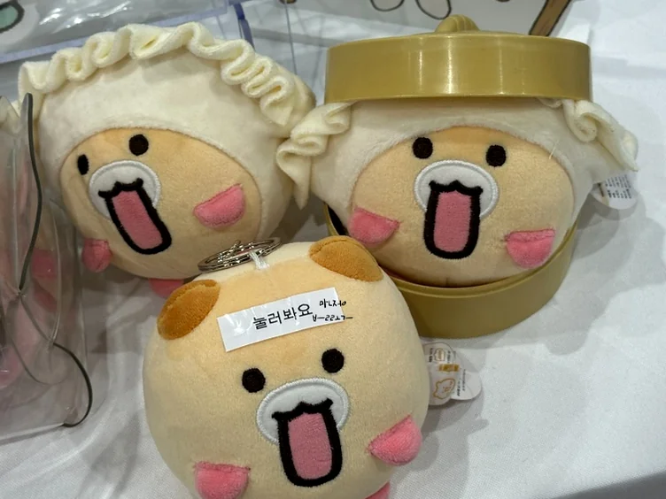 A close-up of charming dumpling-shaped character plushies, representing the tactile and whimsical 'Kidult' merchandise trends found within the fair. - The Architectural Pulse of Creativity: K-Illustration Fair Magok 2026