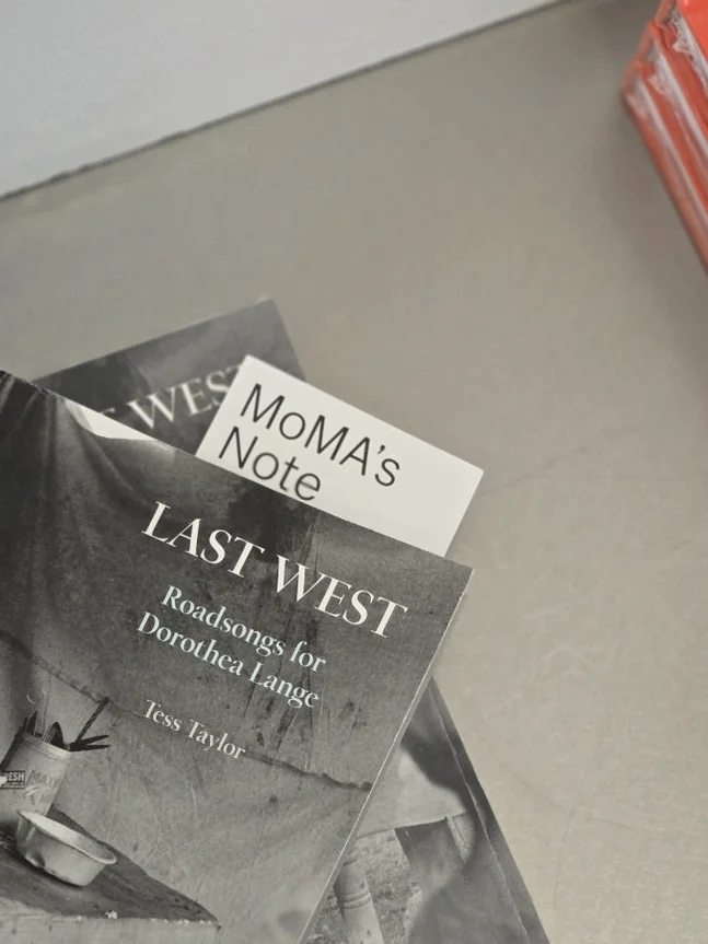 A close-up of 'LAST WEST: Roadmaps for Dorothea Lange' nestled with a discreet 'MoMA's Note' bookmark, symbolizing the bookstore's commitment to curated selections of significant art and photography publications.</div - MoMA Bookstore Seoul: A Curated Sanctuary for Art and Design