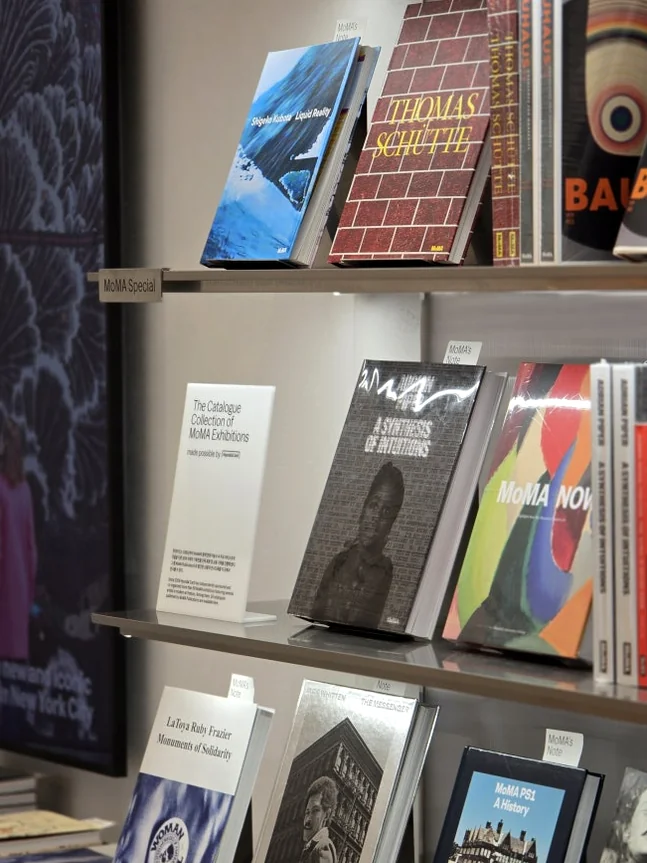 An elegant interior perspective showcasing a diverse collection of art and design books neatly arranged on minimalist, illuminated shelves, creating an inviting atmosphere for visitors to explore and engage. - MoMA Bookstore Seoul: A Curated Sanctuary for Art and Design