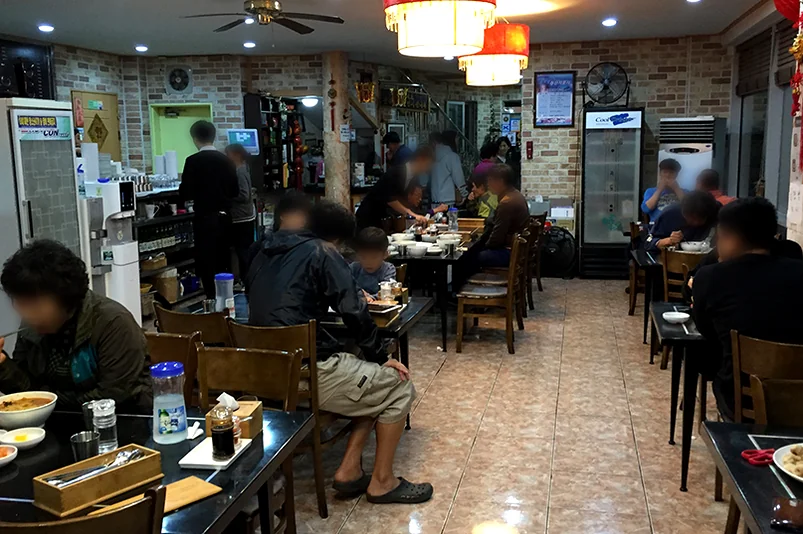 A steaming bowl of Blue Crab Jjambong at Deokseongwon, showcasing the rich, reddish broth and the generous portions of crab that define this signature dish. - Jeju Heritage Gastronomy: The Timeless Allure of Deokseongwon Seogwipo