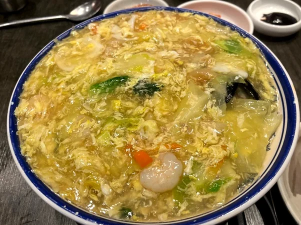 A close-up of the delicate, thin noodles used in Deokseongwon's Jjambong, perfectly absorbing the oceanic flavors of the crab broth. - Jeju Heritage Gastronomy: The Timeless Allure of Deokseongwon Seogwipo