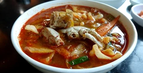 A top-down view of the dining table at Deokseongwon, featuring the iconic Jjambong alongside classic side dishes like danmuji and kkakdugi. - Jeju Heritage Gastronomy: The Timeless Allure of Deokseongwon Seogwipo