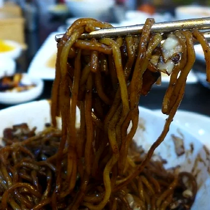 The iconic signage of Deokseongwon at dusk, its lights glowing as a beacon for hungry travelers and locals alike in the Seogwipo evening. - Jeju Heritage Gastronomy: The Timeless Allure of Deokseongwon Seogwipo