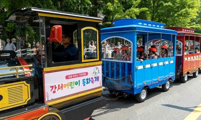 A child posing at the Giant Flower photo zone, creating a surreal visual - Narrative Arc at Banghwa Neighborhood Park: The 2026 Gangseo Fairy Tale Festival