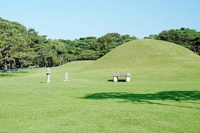 The majestic silhouettes of the five royal tombs rising from a lush green velvet lawn, symbolizing the eternal peace and geographic essence of the Silla dynasty's royal resting place. - Gyeongju Oreung: The Architectural Silence of Silla’s Sacred Five