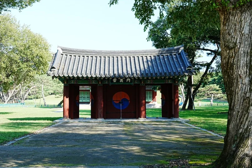 The ceremonial entrance gate standing as a sacred threshold, welcoming visitors into the quiet, protected landscape of the royal tomb complex. - Gyeongju Oreung: The Architectural Silence of Silla’s Sacred Five