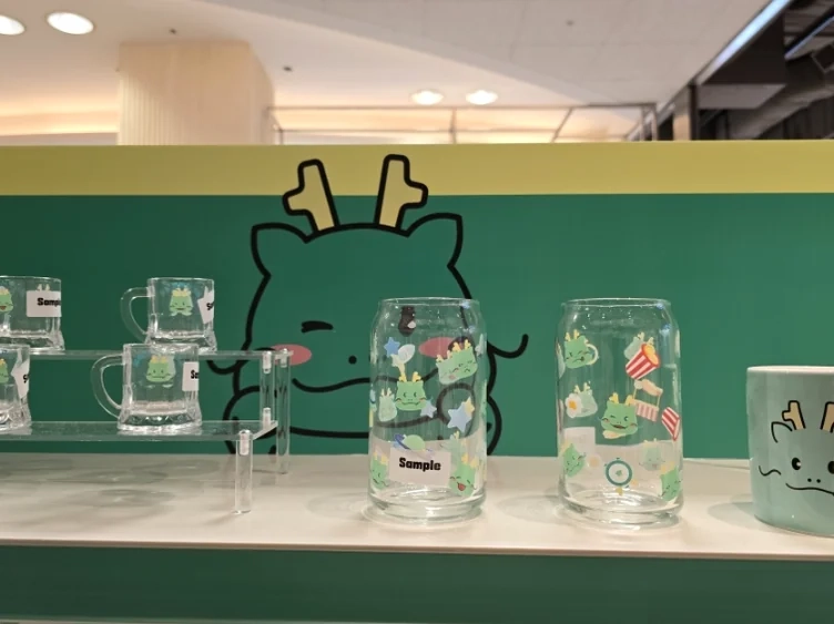 A collection of Joayong-themed mugs and clear glasses, each adorned with cute character illustrations, offering practical yet charming keepsakes for fans. - Joayong's Popcorn Journey: E-Mart Borajum's Premier Character Pop-Up