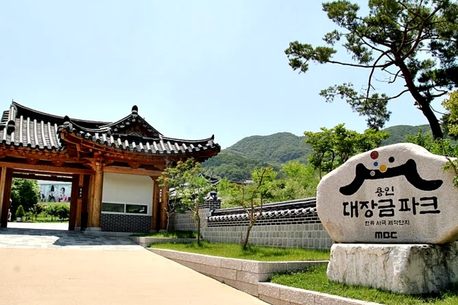 Interior view of a luxury caravan featuring a comfortable double bed and modern kitchenette - Cinematic Grandeur: Architectural Time Travel at Yongin Daejanggeum Park