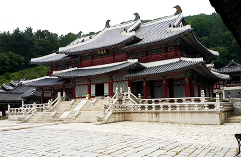 The entrance sign of the glamping site with the historical park visible in the background - Cinematic Grandeur: Architectural Time Travel at Yongin Daejanggeum Park