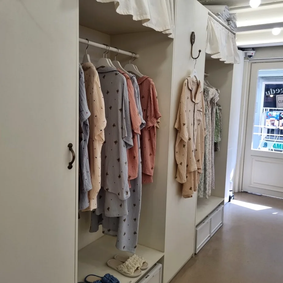 A delightful close-up of a cream-colored pajama set, adorned with cheerful orange fruit patterns, highlighting the soft, breathable fabric and the playful, inviting design. - Beyond Comfort: The Curated Pajama Sanctuary of Yeonnam-dong, Juuneedu Showroom