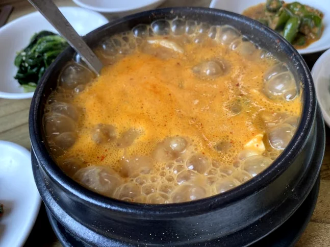 A bubbling stone pot of Cheonggukjang, its deep aroma from soybeans. - Ancestral Umami: Geumseong Restaurant Yangji Yongin