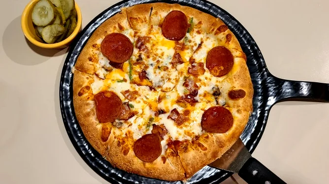 Kimchi fried rice served on a steaming hot iron skillet - Gastronomic Icon: The Definitive Guide to Lee Jae-mo Pizza Main Store