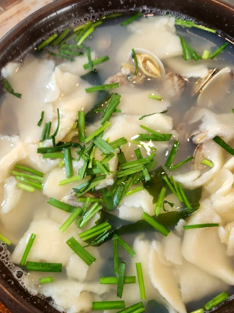 A steaming pot of HanGaRi SuJeBi in a traditional vessel. - The Culinary Hermitage of Suncheon: A Refined Guide to Songchi Maeul