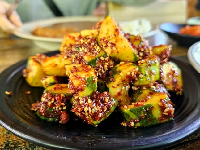 Close-up of signature Oi MuChim glistening with red pepper seasoning. - The Culinary Hermitage of Suncheon: A Refined Guide to Songchi Maeul