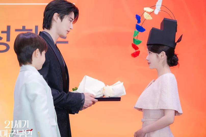 A dynamic scene from a press event, featuring lavish attire and floral arrangements, adding a touch of glamour. - 21st Century Grand Prince's Lady: A Royal Romance Redefined (K-Drama Review)