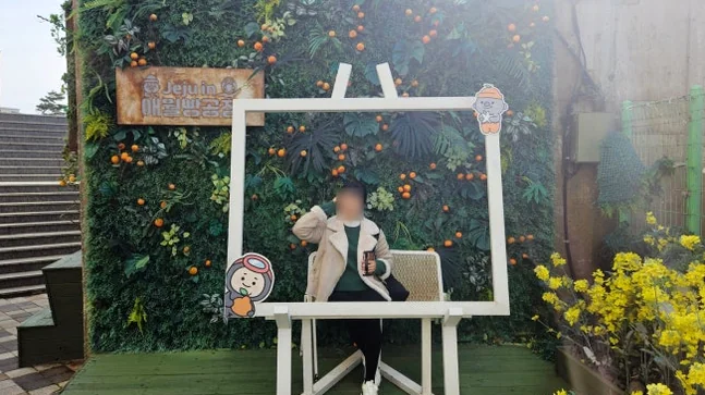 Outdoor photo zone decorated with fresh artificial flowers and a white frame - Coastal Crust and Artisanal Calm: The Definitive Guide to Aewol Bread Factory Jeju