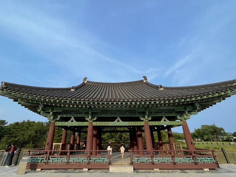 A majestic front view of a traditional palace pavilion standing proudly under a clear blue sky - Beyond the Moonlight: The Timeless Allure of Gyeongju Donggung Palace and Wolji Pond