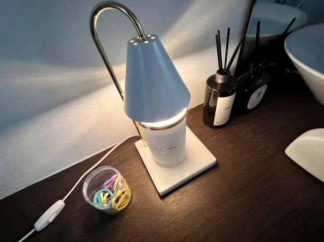 White desk lamp and glass diffuser bottles on a dark wooden surface - 2026年、光化門で心身を解きほぐす。究極のウェルネスと美食を巡るソウル・エディターズ・ガイド