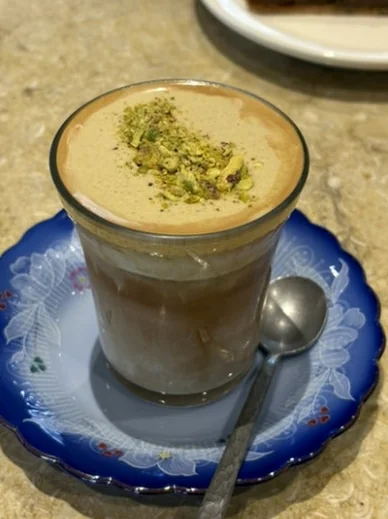 A cup of pistachio latte served on a decorative blue and white saucer - ジェンダーニュートラルな美の聖地。聖水洞 'ラカ (Laka)' フラッグシップストア完全ガイド